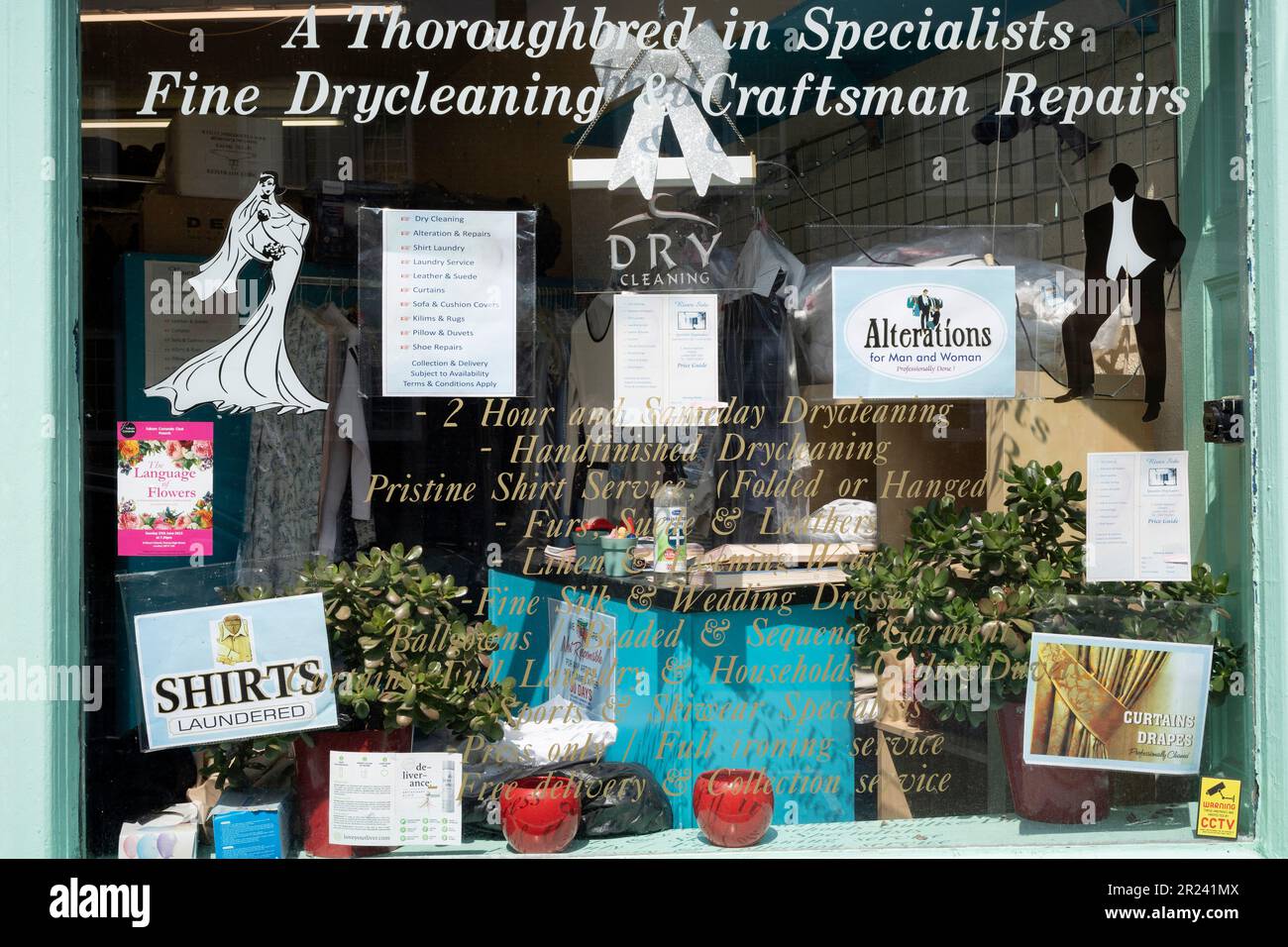 A detail of a dry cleaning service window in Hurlingham, Putney, on