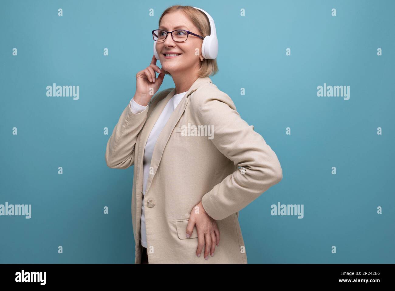 50s a woman in a jacket masters the technique for listening to music in
