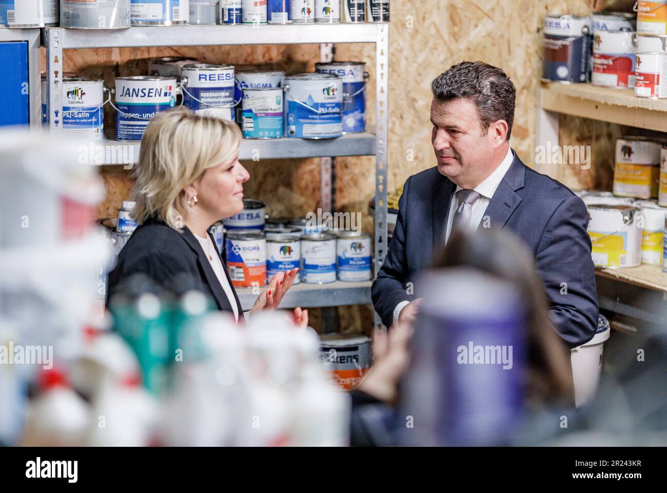 Osterby, Germany. 17th May, 2023. Hubertus Heil (SPD), Federal Minister of Labor, talks to the owner, master painter Jessica Hansen, during a visit to the business 'Die Malerin'. The minister thus fulfills his promise from the broadcast 'Hart aber fair' on March 13, 2023. Hansen has introduced the four-day week in her business and has had positive experience in recruiting skilled workers. Credit: Axel Heimken/dpa/Alamy Live News Stock Photo