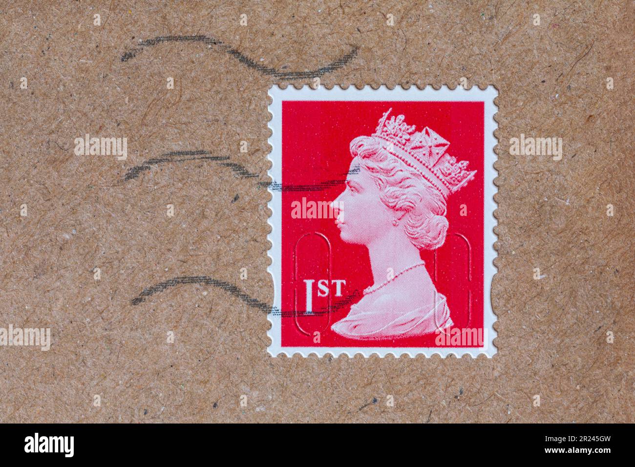 1st class stamp with Queens head on brown envelope Stock Photo Alamy