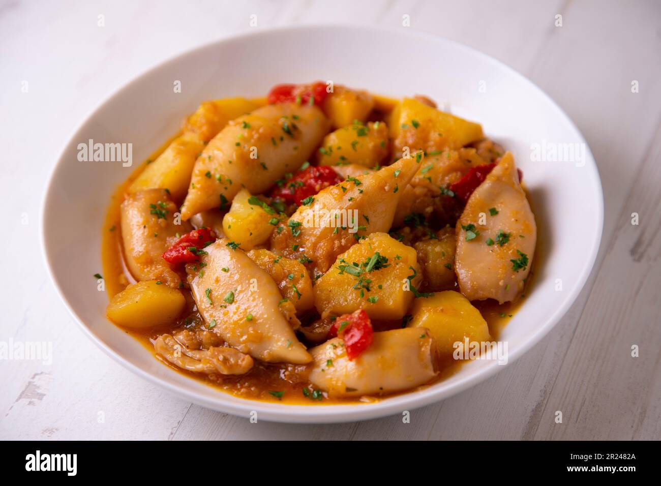 Baby Squid stew with potatoes and prawns. Traditional Spanish recipe