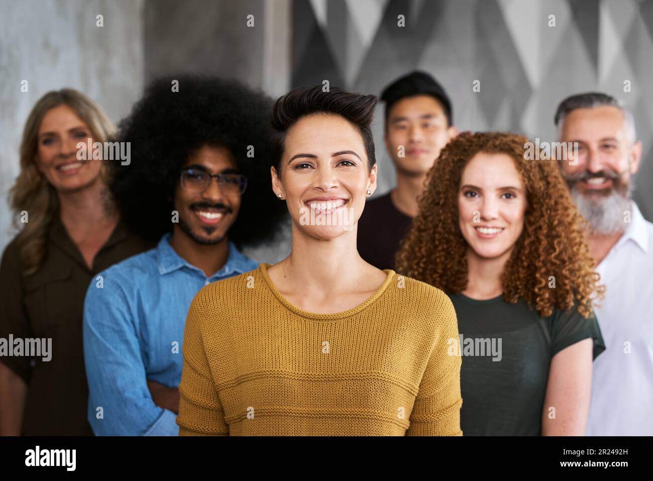 We thrive on success. Cropped portrait of a group of designers standing ...