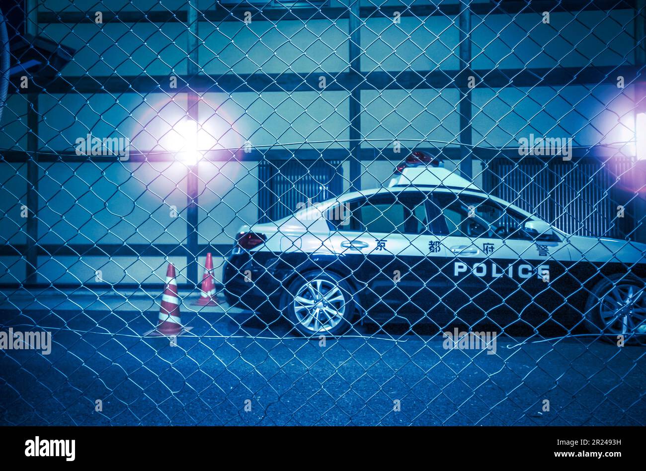 Kyoto- Japan- Circa November 2018. Police car at vigilance night behind wire fence with lights. Stock Photo