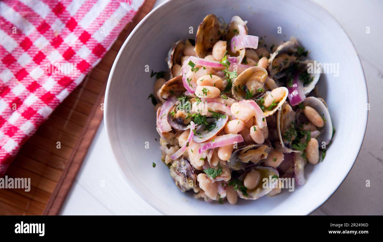 White beans with onion and clams. Traditional northern Spanish recipe Stock Photo Alamy