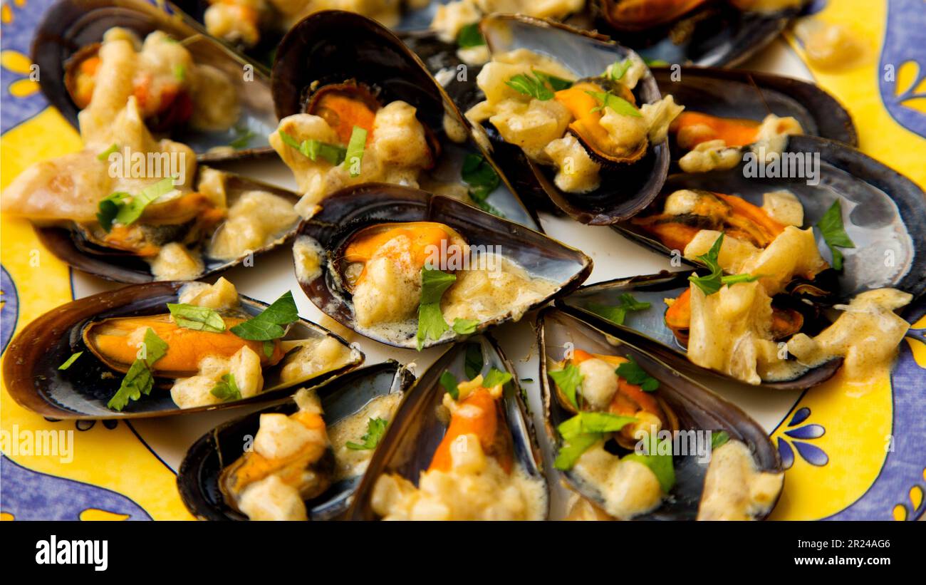 Steamed mussels with vegetables and sauce. Traditional Spanish tapa
