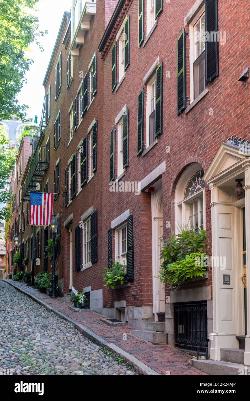 Boston, MA, USA-August 2022; Vertical view down Acorn Street with cobblestones and former coachmen homes in the Beacon Hill neighborhood Stock Photo