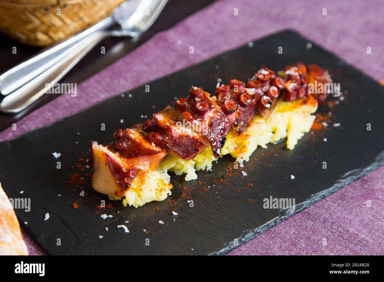 Pulpo a la Gallega. Octopus cooked with boiled potato, paprika and olive oil. Galician octopus recipe north of Spain tapa. Stock Photo