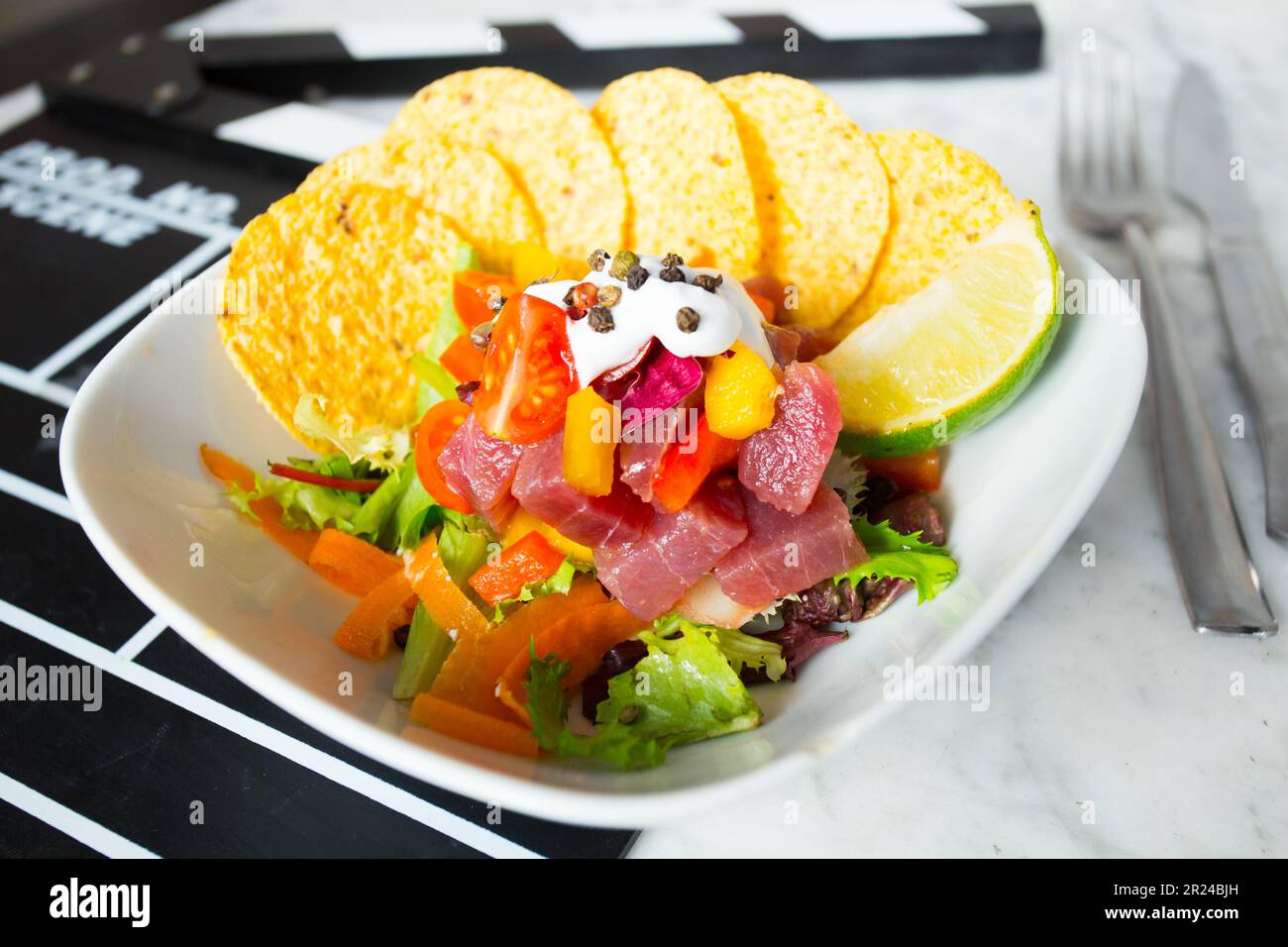 Tuna tartare is prepared with fresh raw tuna and seasonings. It is commonly spread on a cracker