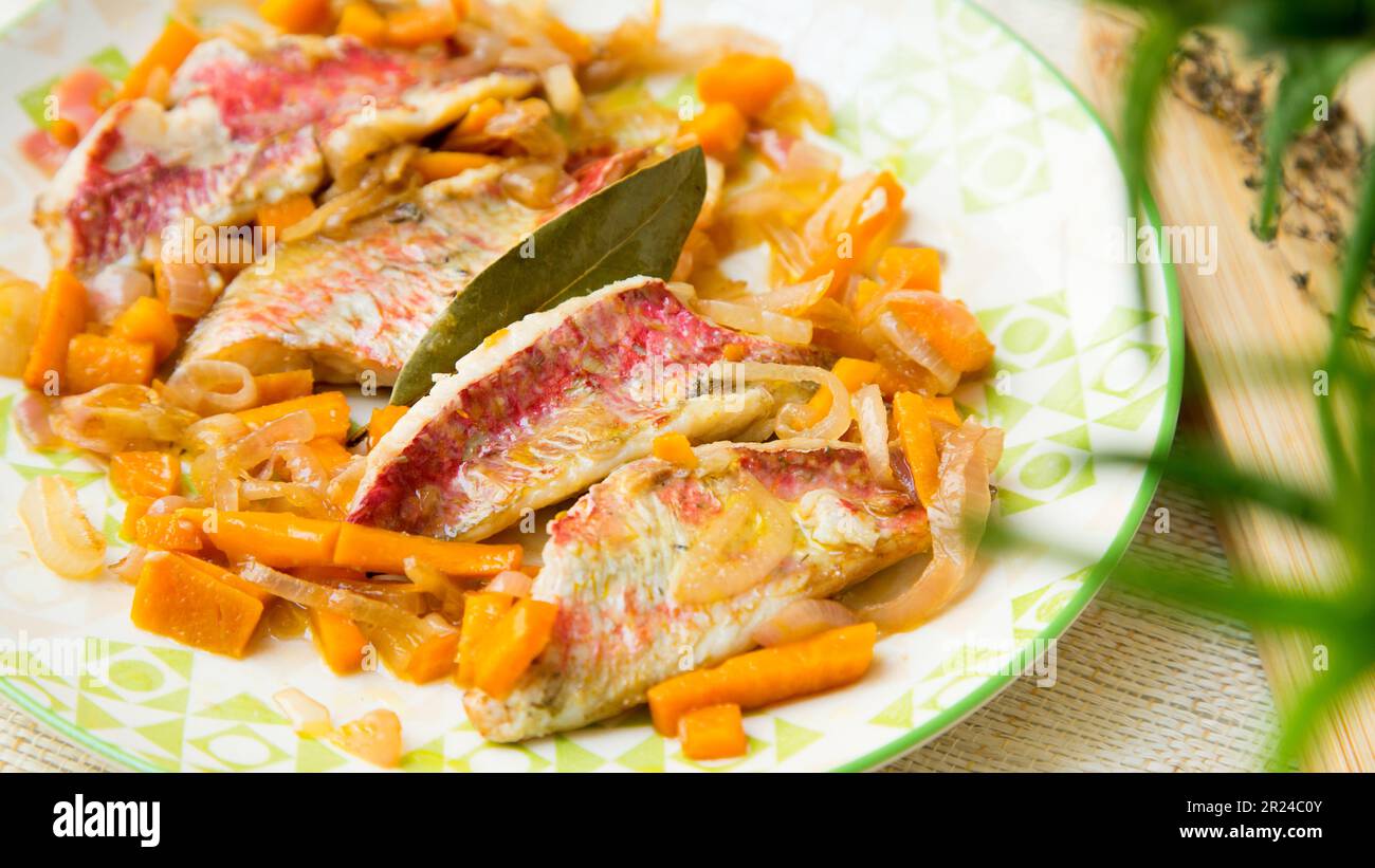 Plate of top quality red mullets cooked in the oven with vegetables in