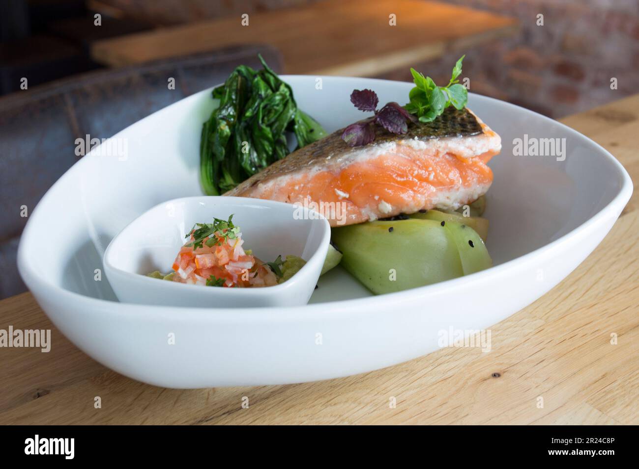 Top quality salmon dish cooked in the oven with vegetables in a luxury restaurant. Stock Photo
