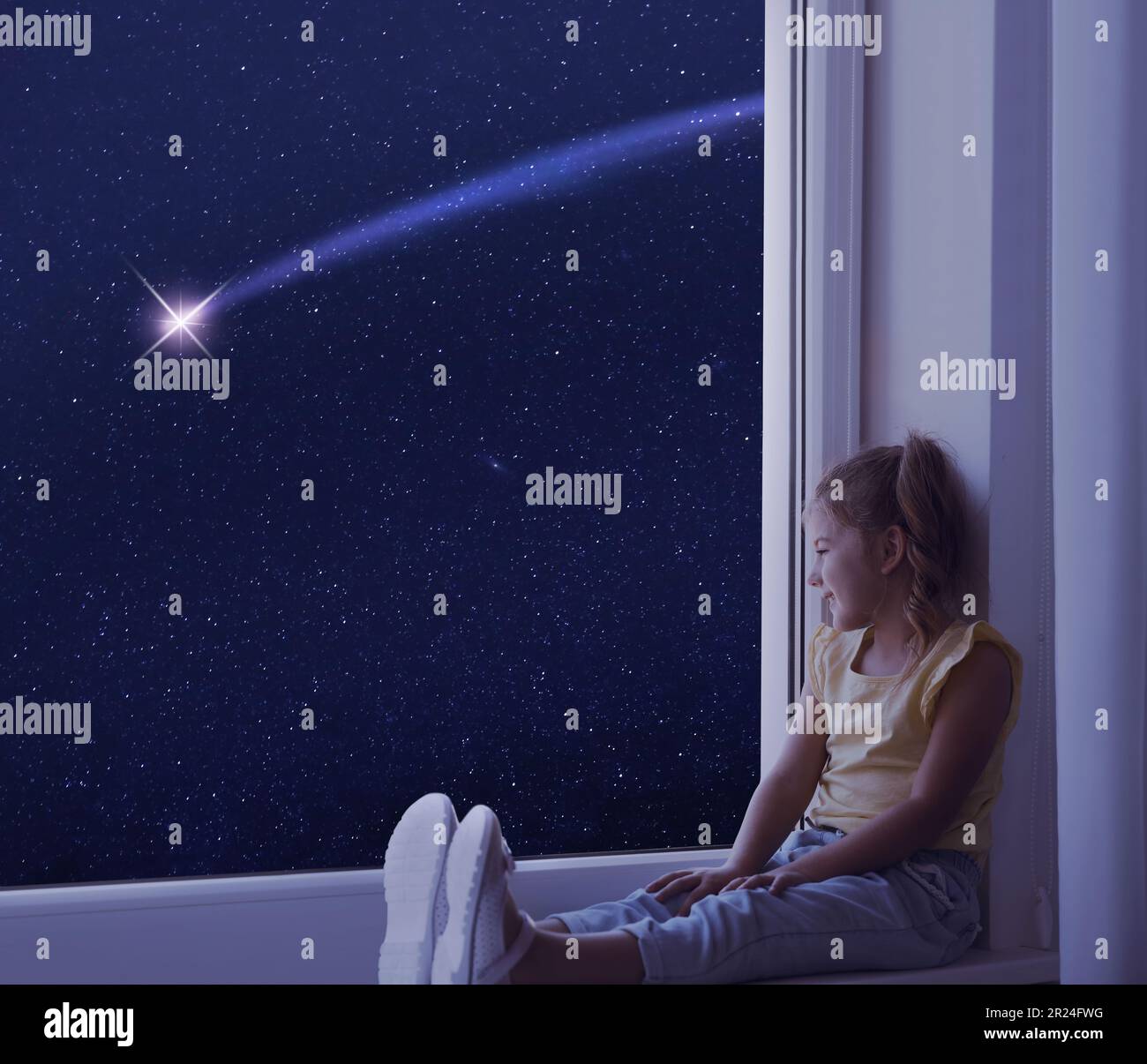 Cute little girl sitting on windowsill and looking at shooting star in ...