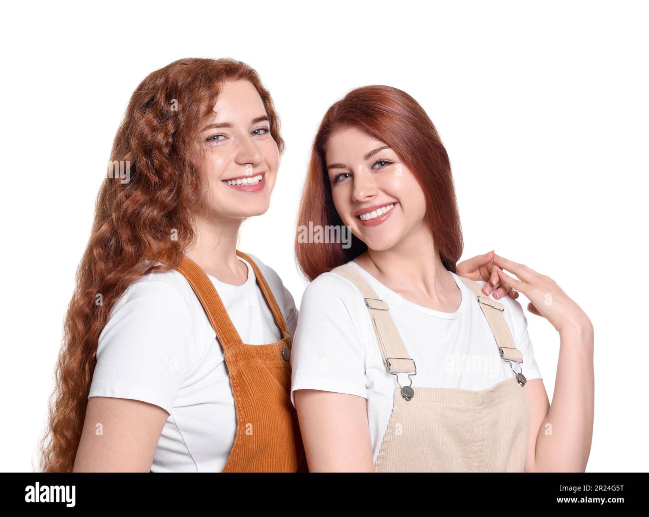 Portrait of beautiful young redhead sisters on white background Stock