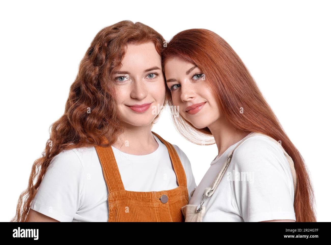 Portrait of beautiful young redhead sisters on white background Stock