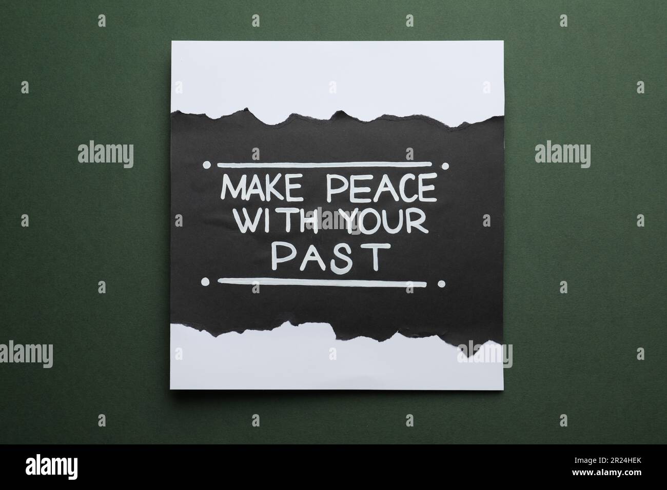 Card with life-affirming phrase Make Peace With Your Past on dark green background Stock Photo