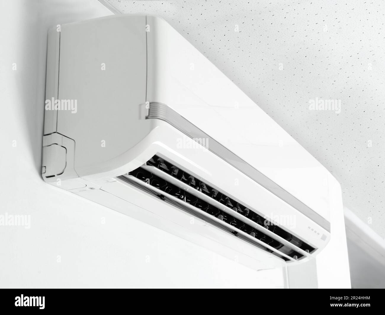 Modern air conditioner on white wall indoors Stock Photo - Alamy