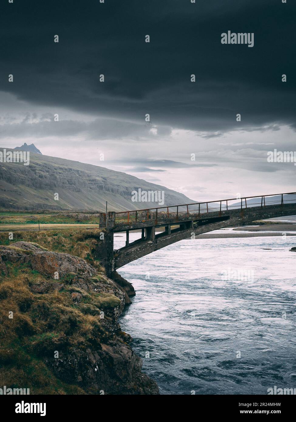A spectacular view of a bridge arching over a body of water in the East Fjords, Iceland Stock Photo