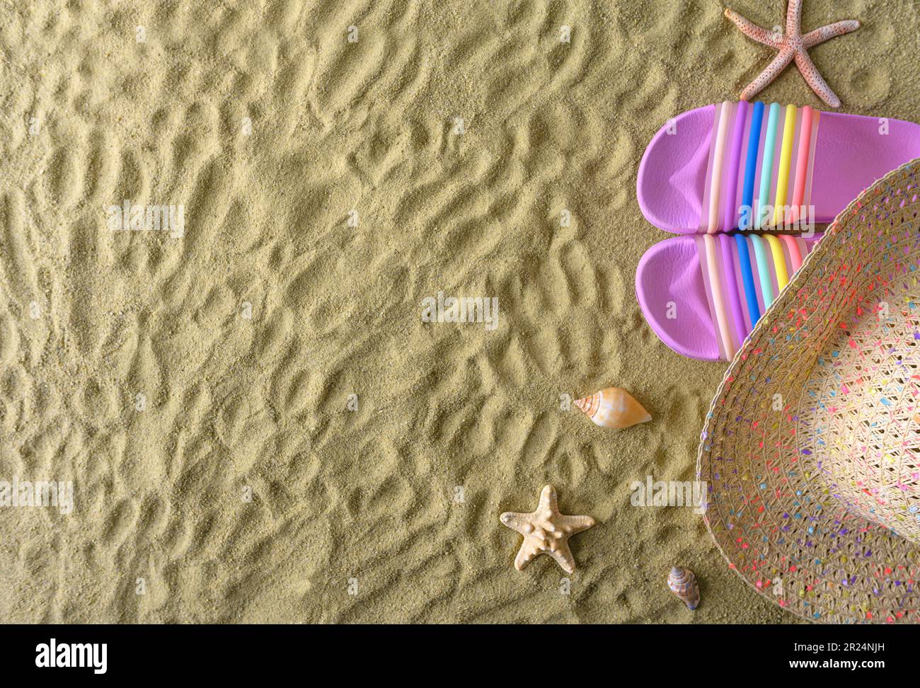 Hat, flip flops and shells on the beach Stock Photo - Alamy