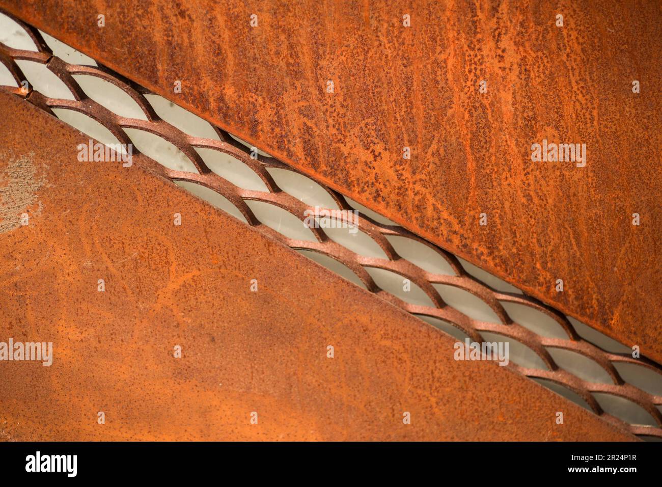 rusty metal surface close up, with glass in the middle Stock Photo