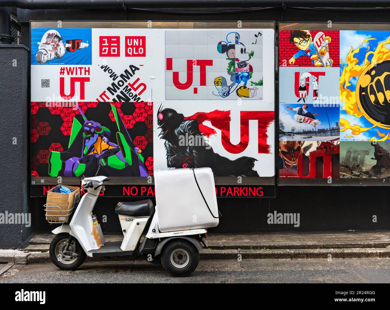 tokyo, harajuku - may 10 2023: Japanese Honda Gyro three-wheeled motorcycle illegally parked in front of a wall with advertise posters featuring japan Stock Photo