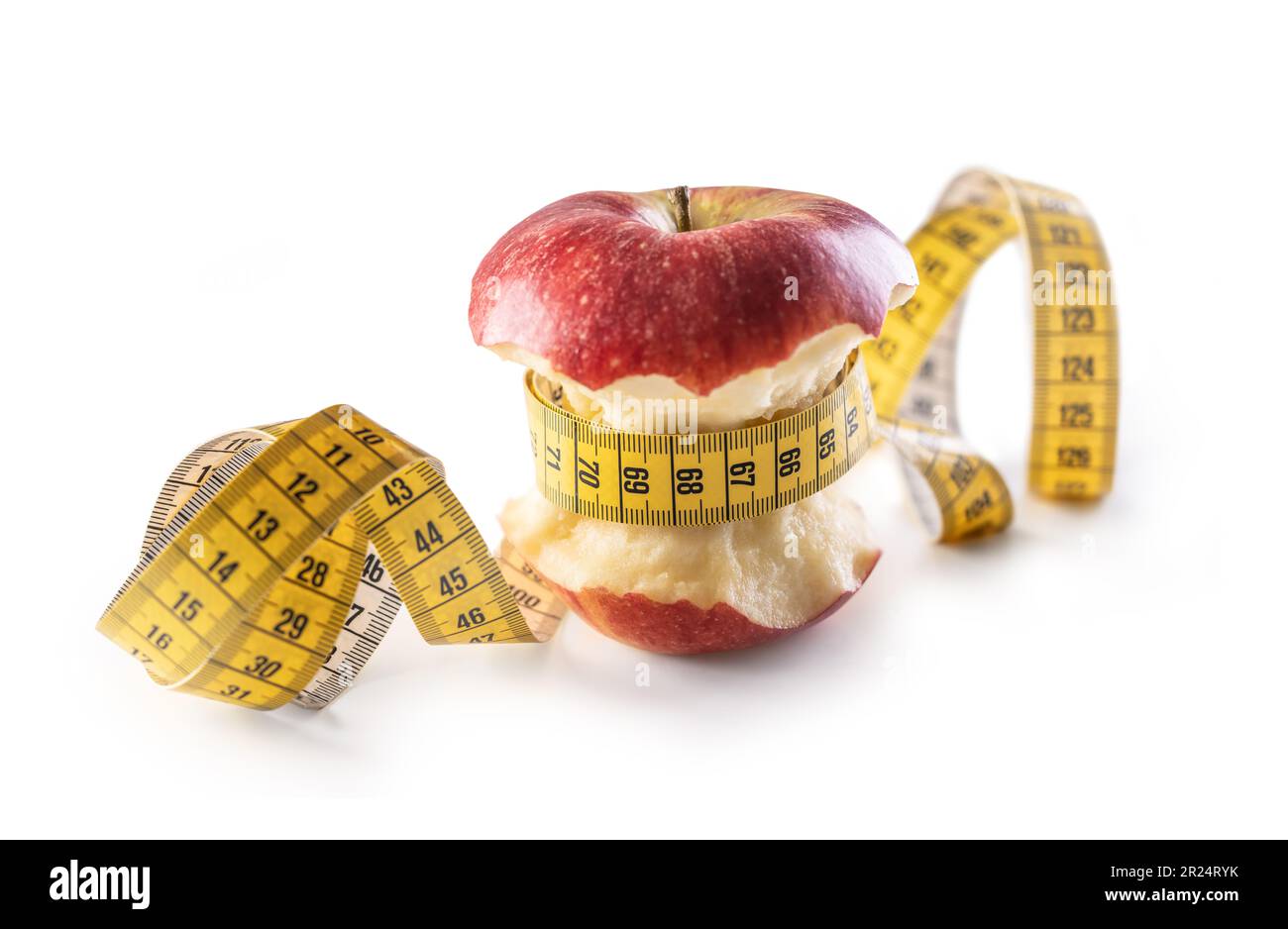 Red apple wrapped with tape measure on isolated white background. Healthy eating and lifestyle concept. Stock Photo