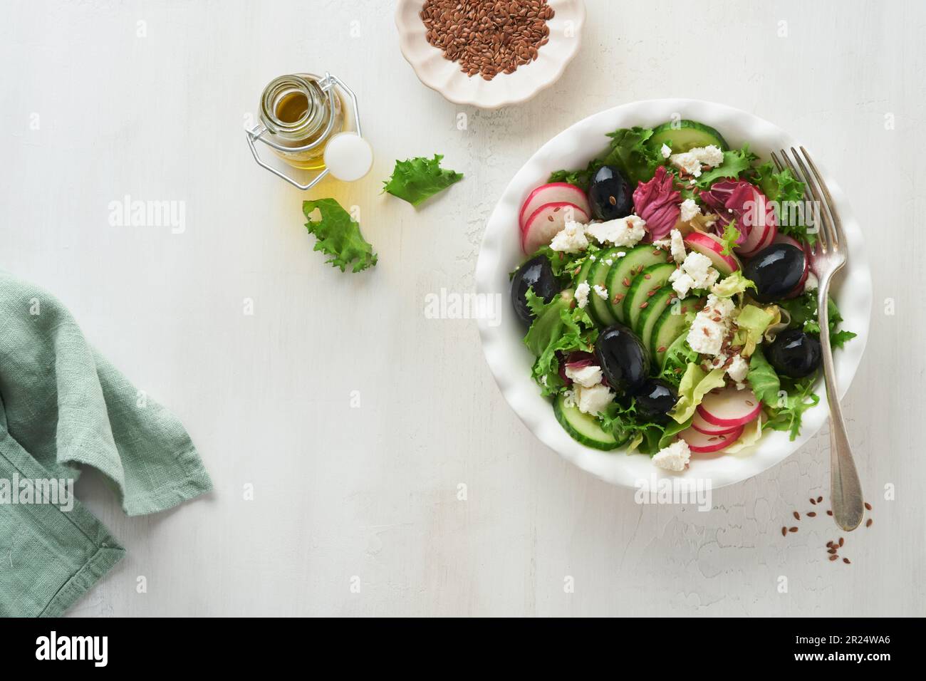 Lettuce salad, cucumber, radish salad with cottage cheese and flax