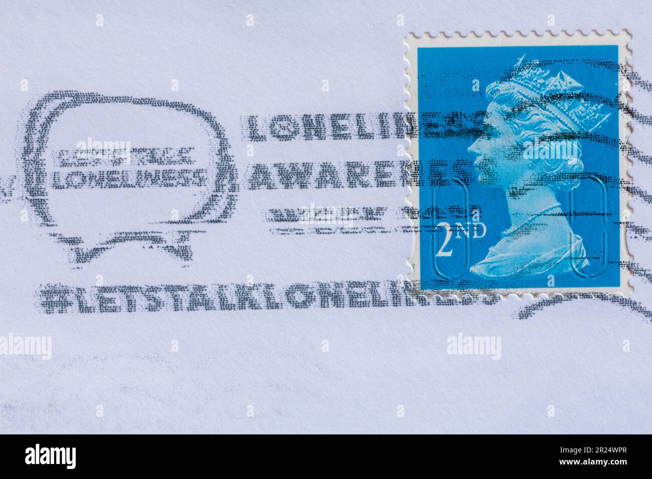 Let's talk loneliness loneliness awareness week message stamped with 2nd class postage stamp on white envelope Stock Photo