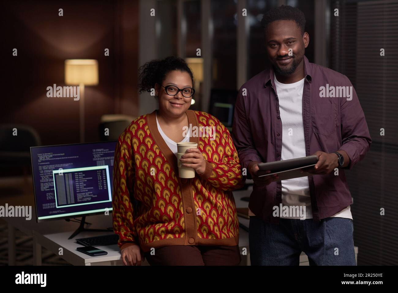 Portrait of couple of programmers working in team together in office during deadline Stock Photo