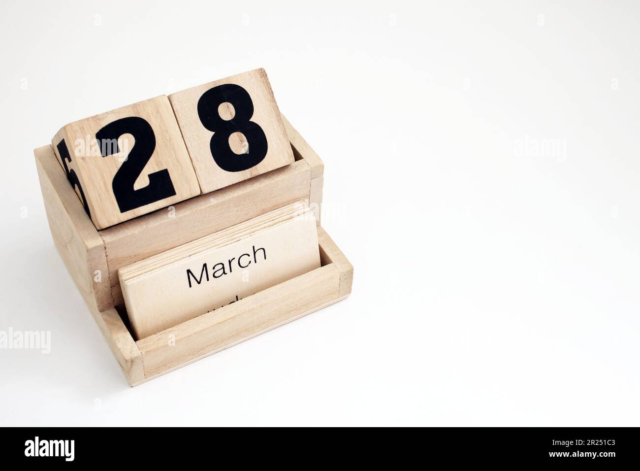Wooden perpetual calendar showing the 28th of March Stock Photo Alamy