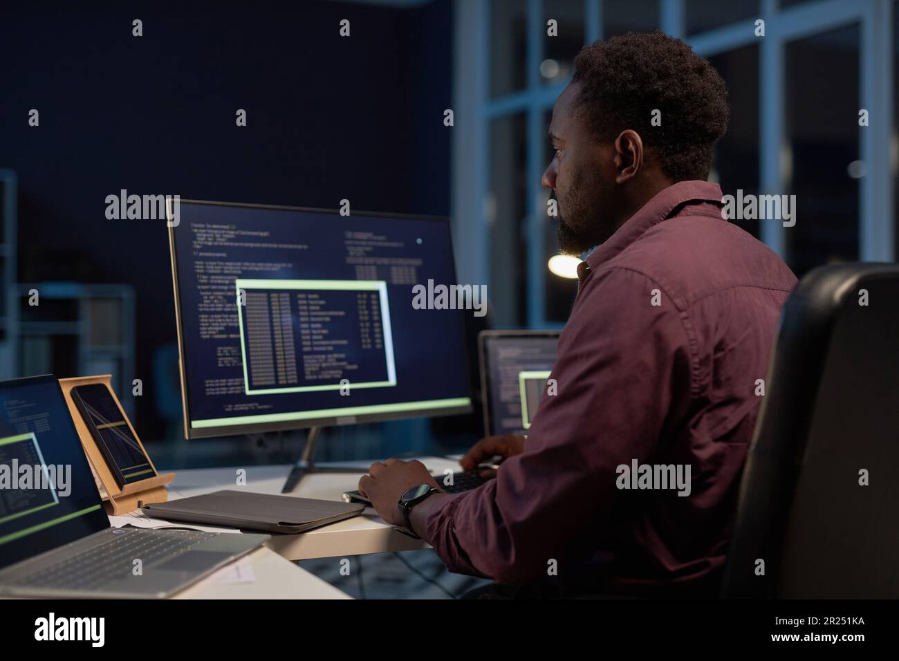 African American developer concentrating on development of software on computer Stock Photo