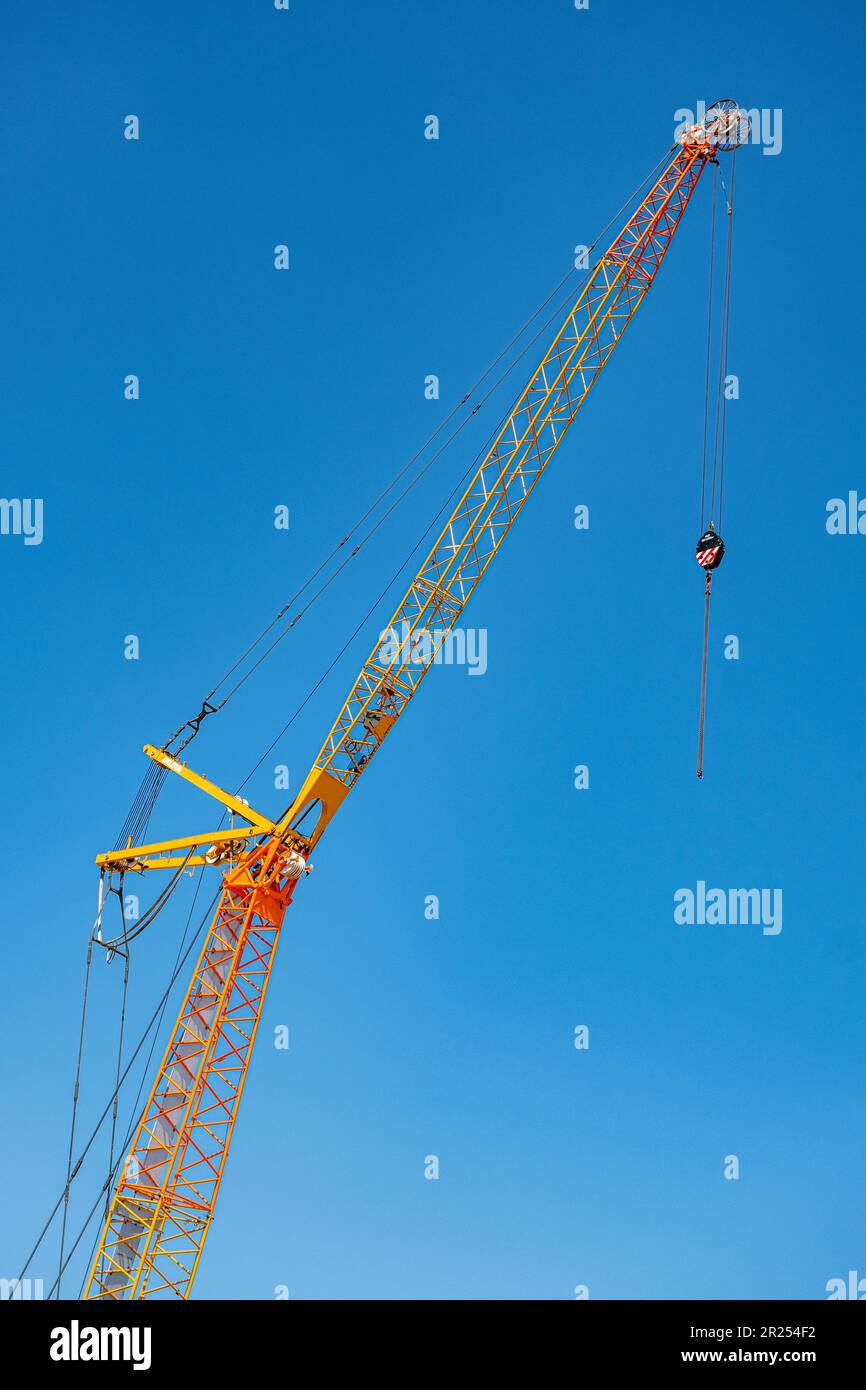 Crane detail, isolated against deep blue sky, on building site UK Stock Photo