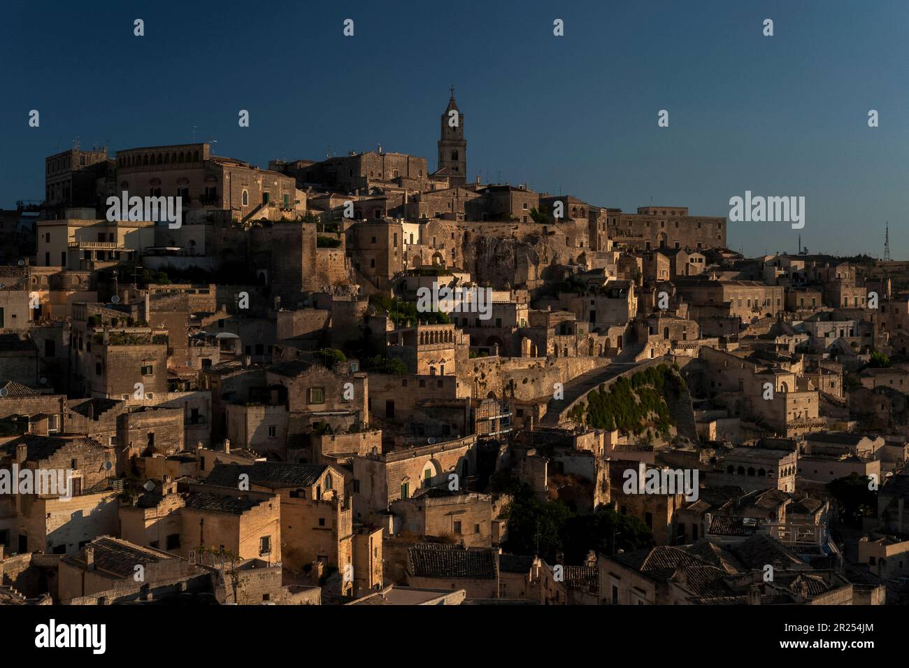 Sunlight on the Sasso Barisano, one of two ‘underground cities’ in Matera, Basilicata, Italy. Troglodyte dwellings have been re-faced and transformed, many with the addition of conventional facades and roof terraces. Stock Photo
