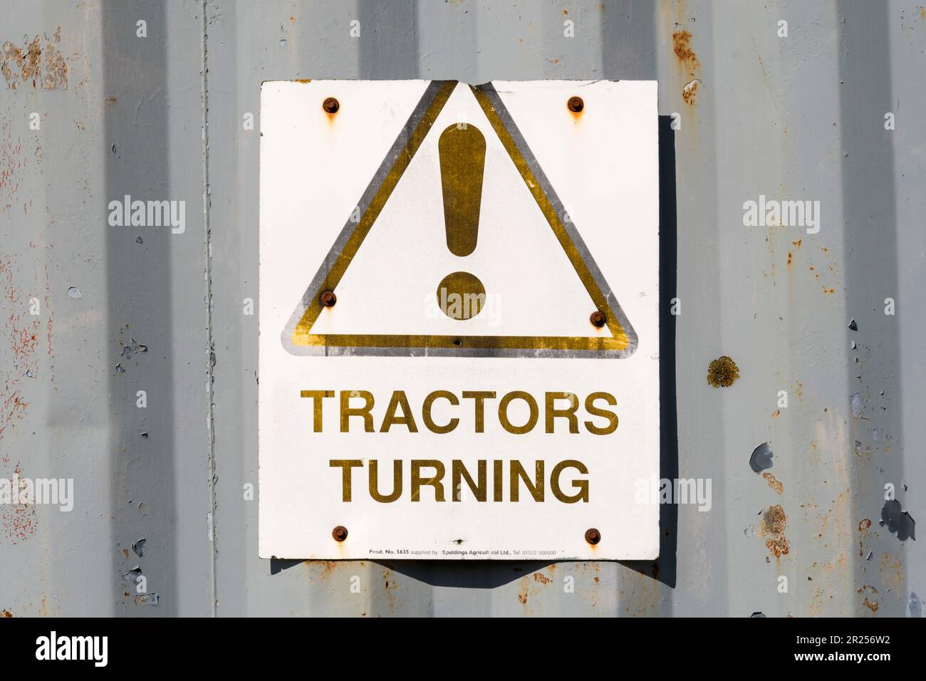 Tractors Turning warning sign on an old farm building Stock Photo Alamy