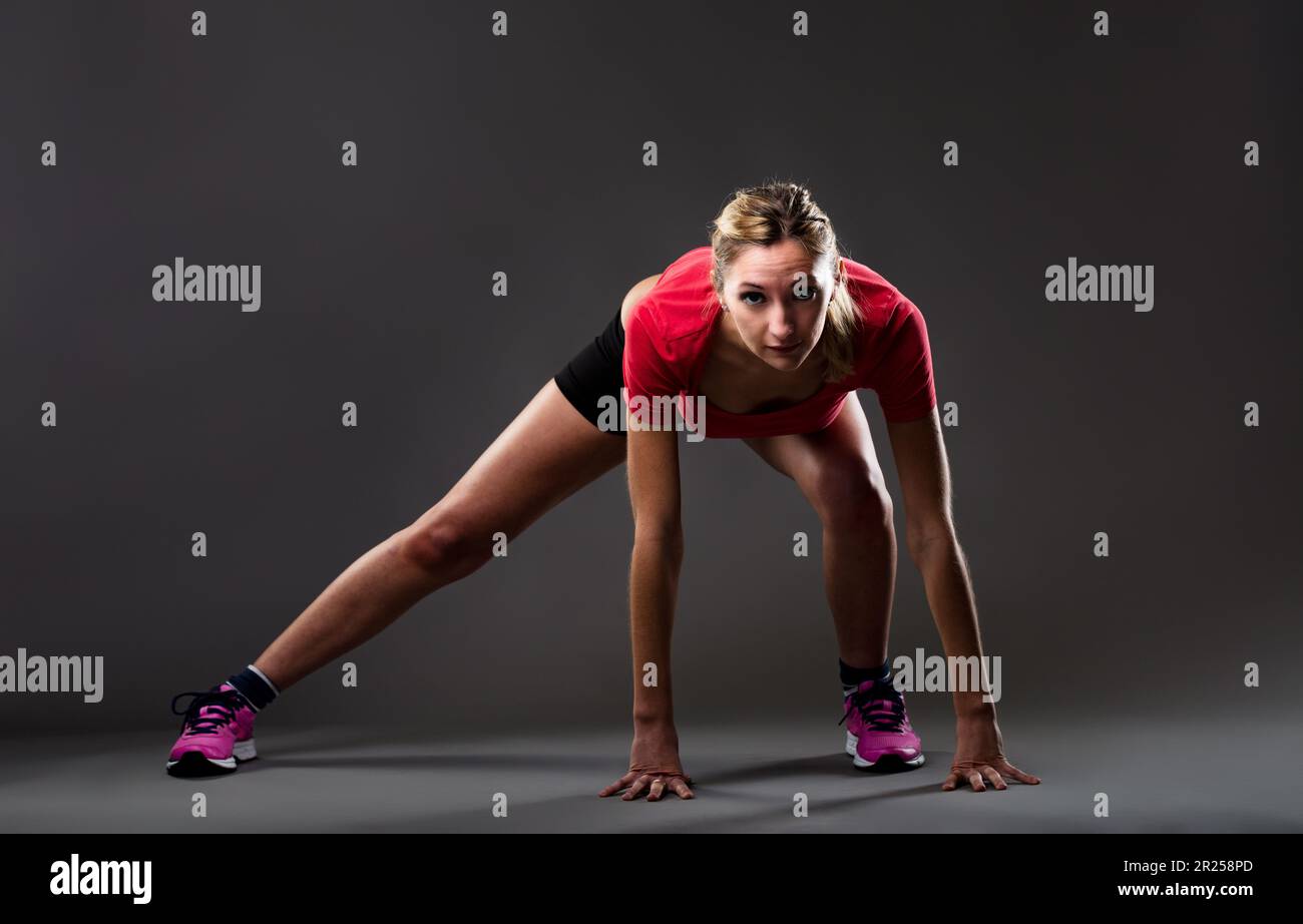 Front view of a blonde woman exercising. Her ground position is like a ...