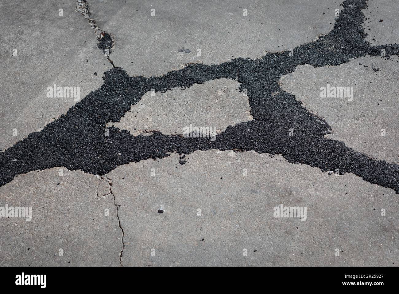Asphaltfilled cracks in concrete slab Stock Photo Alamy