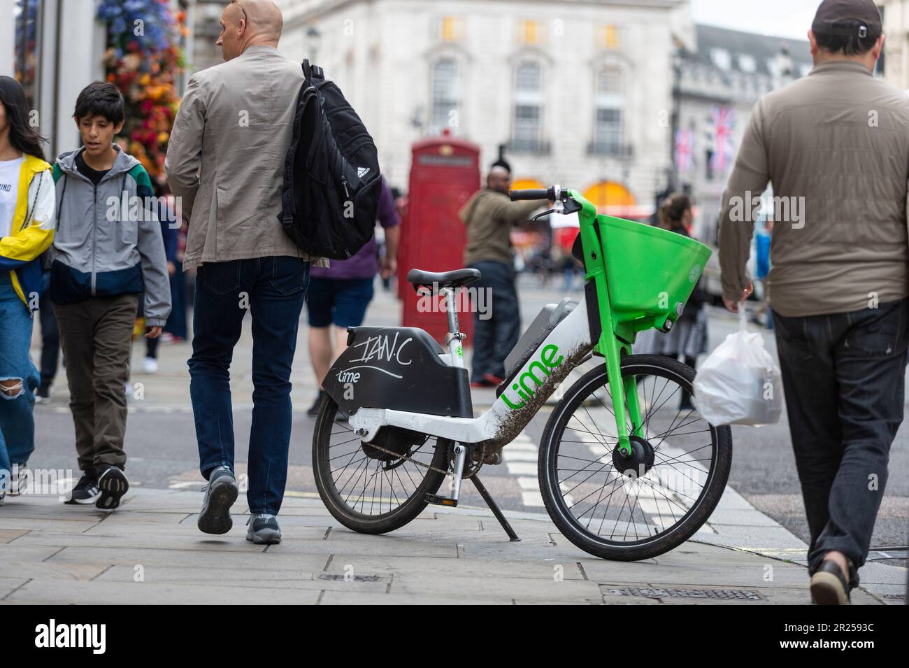 London, UK. 17 May 2023. The public passes an electric hire cycle on a