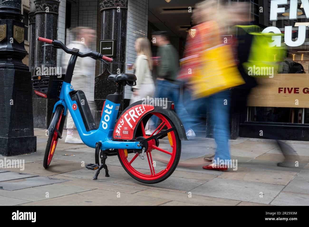 London, UK. 17 May 2023. The public passes an electric hire cycle on a