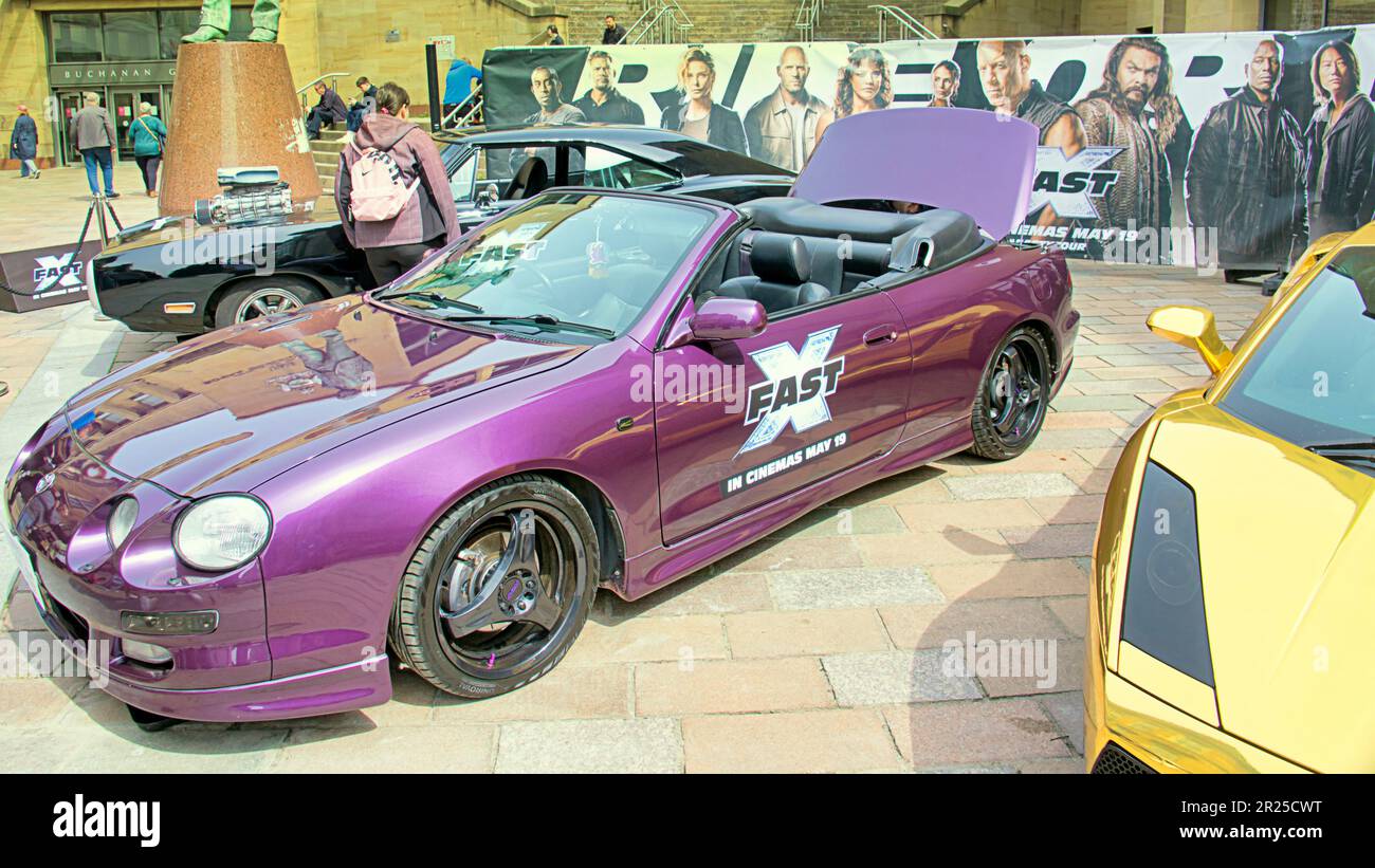 Glasgow, Scotland, UK 17th May, 2023. Fast and the furious franchise cars fastxtour visited the city used for some of its filming as girls and cars found their way to the concert hall steps on Buchanan street before reaching Birmingham tomorrow.. Credit Gerard Ferry/Alamy Live News Stock Photo