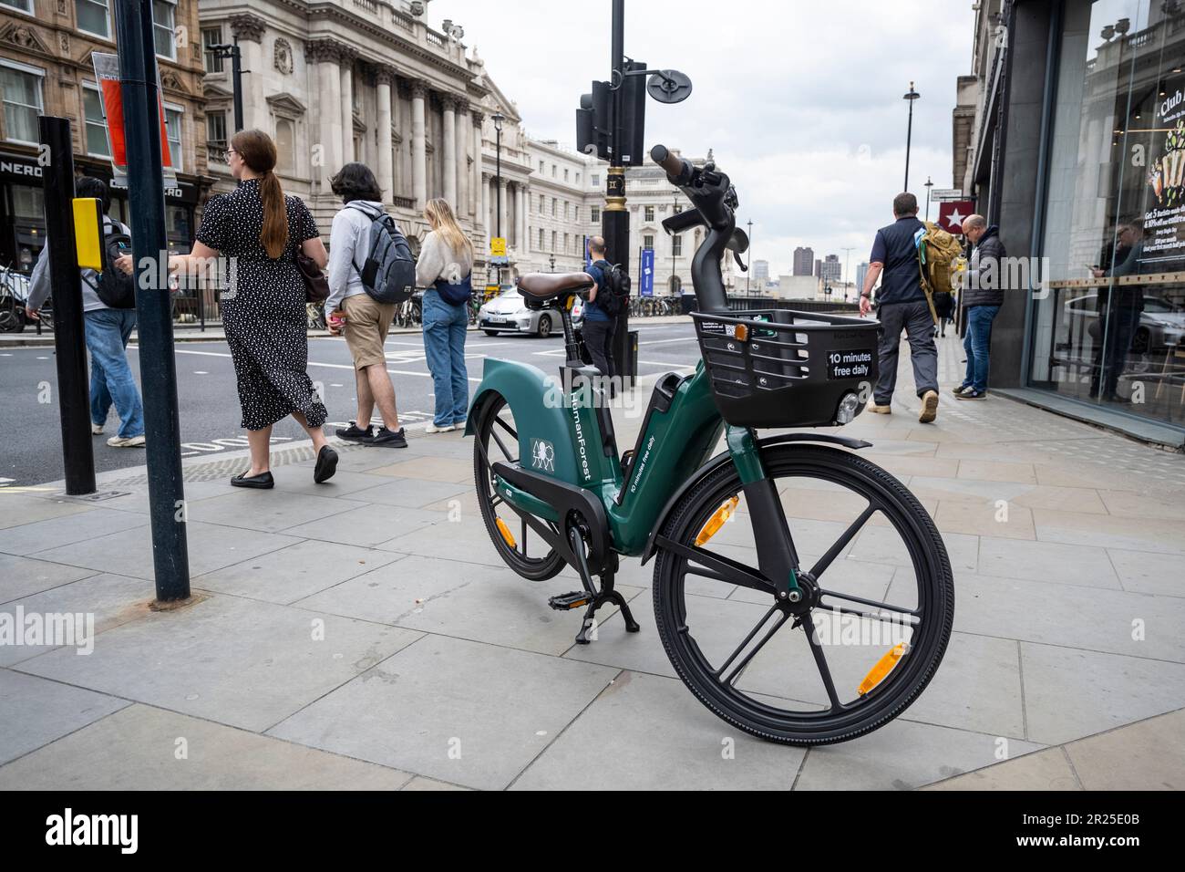 London, UK. 17 May 2023. The public passes an electric hire cycle on a