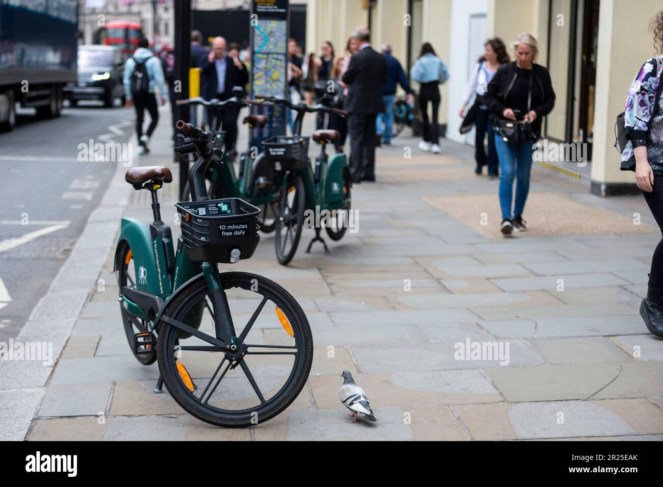 London, UK. 17 May 2023. The public passes electric hire cycles on a