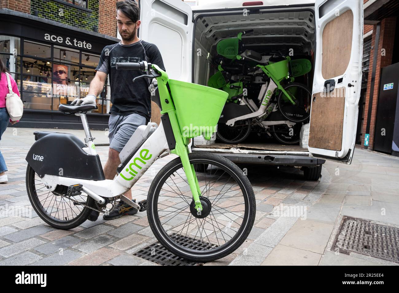 London, UK. 17 May 2023. A technician collects electric hire cycles for