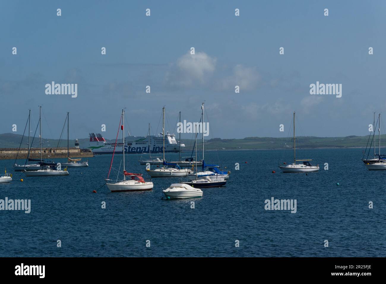 View across Holyhead marina with Stena Line ferry entering the harbour ...