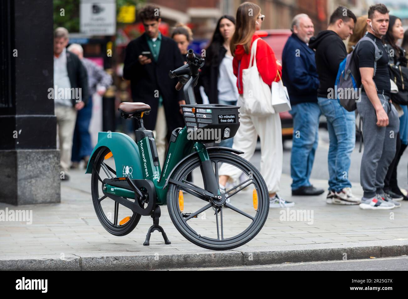 London, UK. 17 May 2023. The public passes an electric hire cycle on a