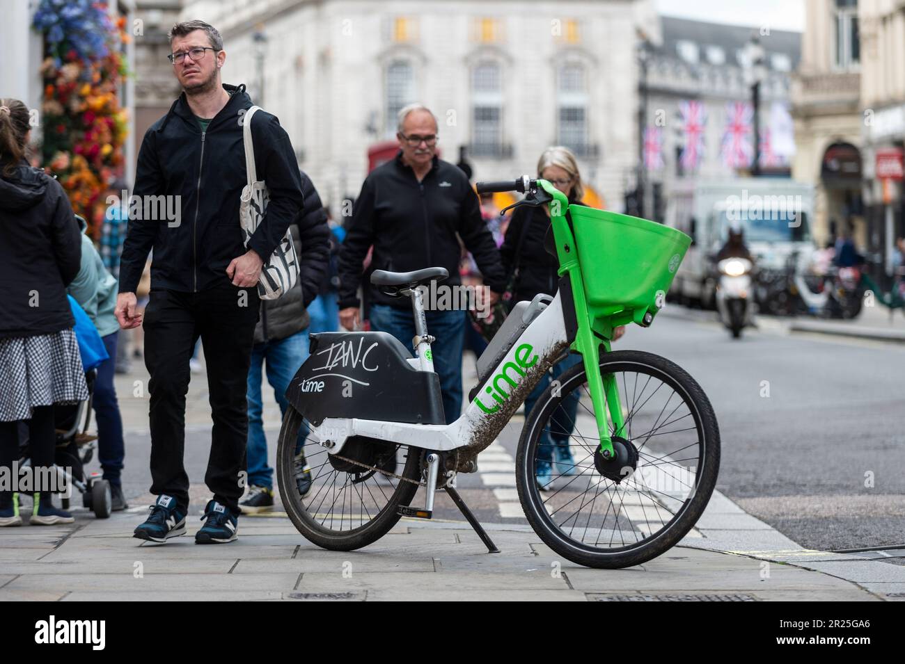 London, UK. 17 May 2023. The public passes an electric hire cycle on a