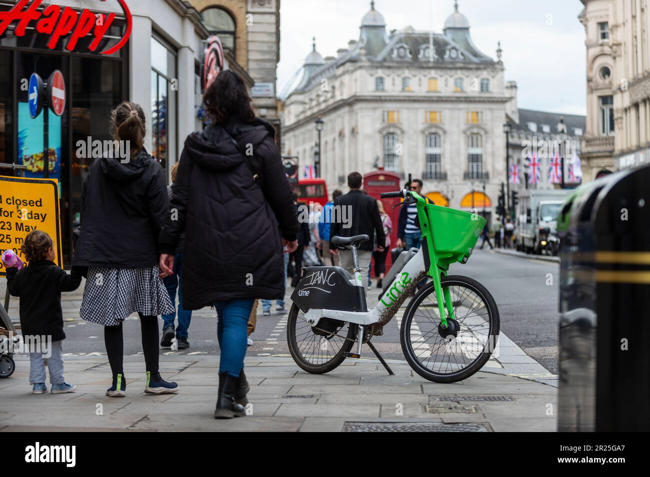 London, UK. 17 May 2023. The public passes an electric hire cycle on a