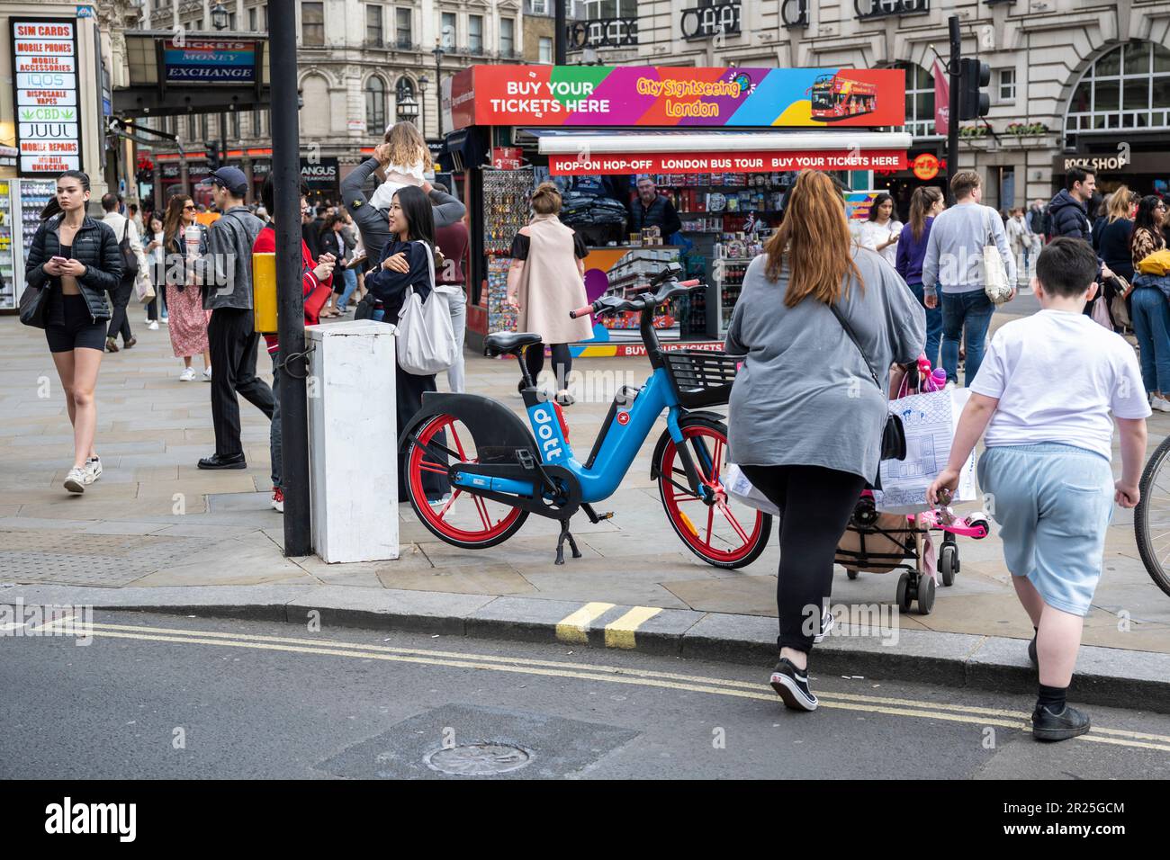 London, UK. 17 May 2023. The public passes an electric hire cycle on a