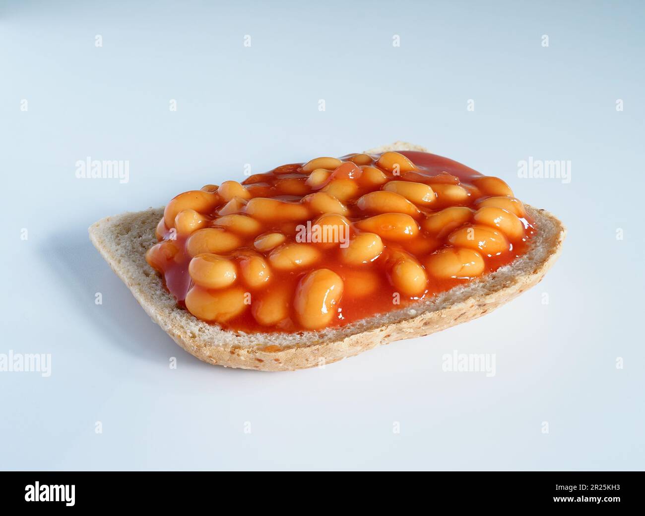 Baked beans on a slice of toast on a white background Stock Photo - Alamy