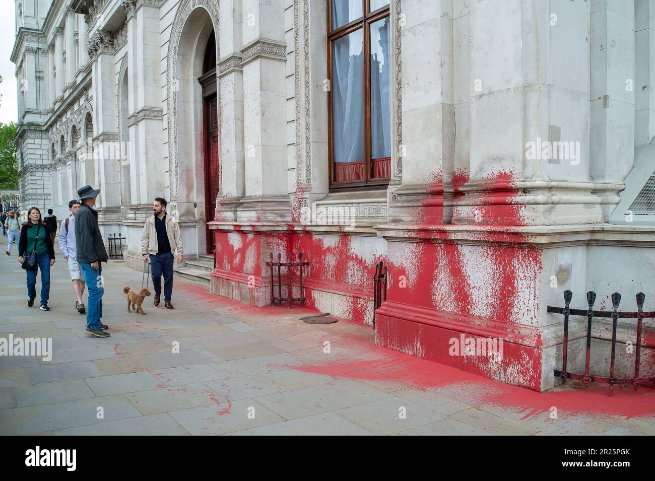 Whitehall, London, UK. 17th May, 2023. Palestine Action have tweeted on Monday 'Palestine Action sprayed Britain's Foreign Office with blood-red paint, to commemorate 75 years since the ethnic cleansing of Palestine began'. Two pro Palestine actionists were arrested for this Nakba 75 action opposite the Cenotaph in Whitehall by the Police. Bemused tourists were walking past the Foreign Office today looking at the aftermath of the red paint sprayed on this historic building. Credit: Alamy Live News Stock Photo