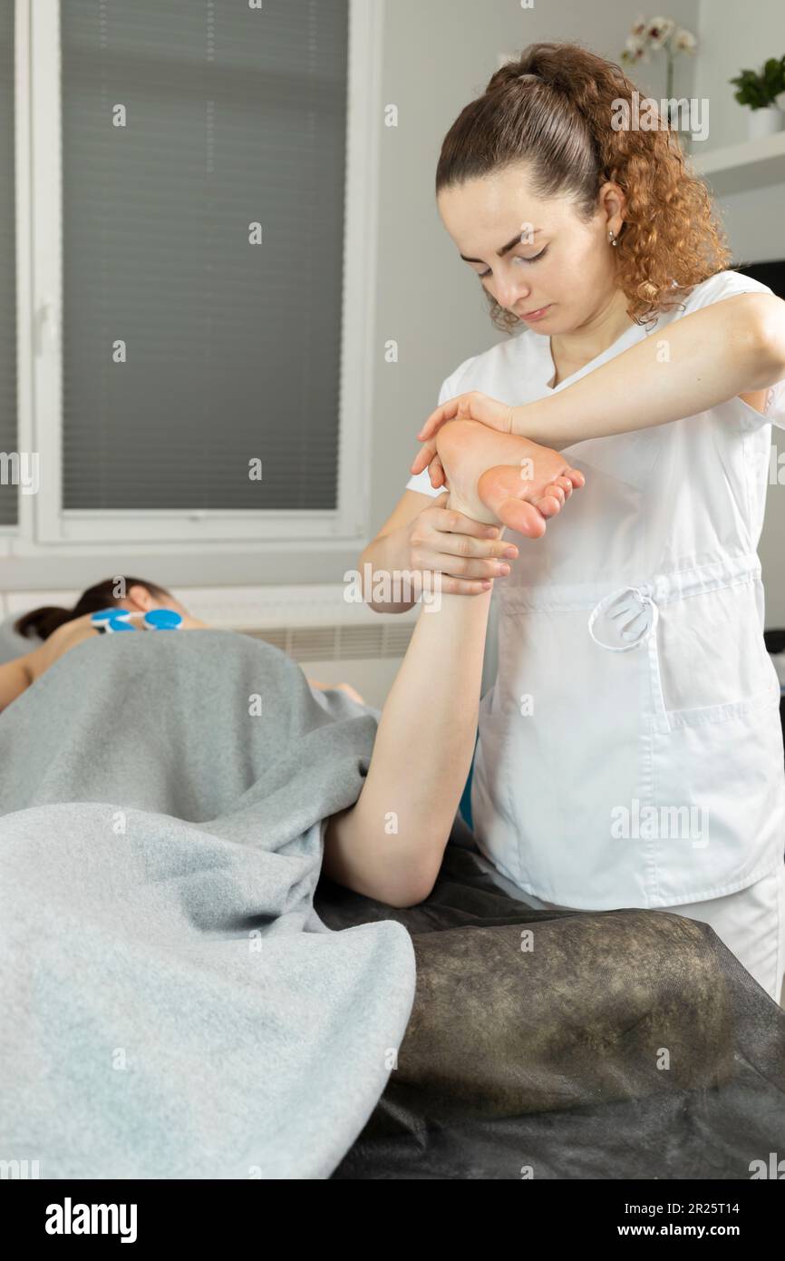 Rehabilitation Specialist, Physical Therapist Makes Foot Massage To