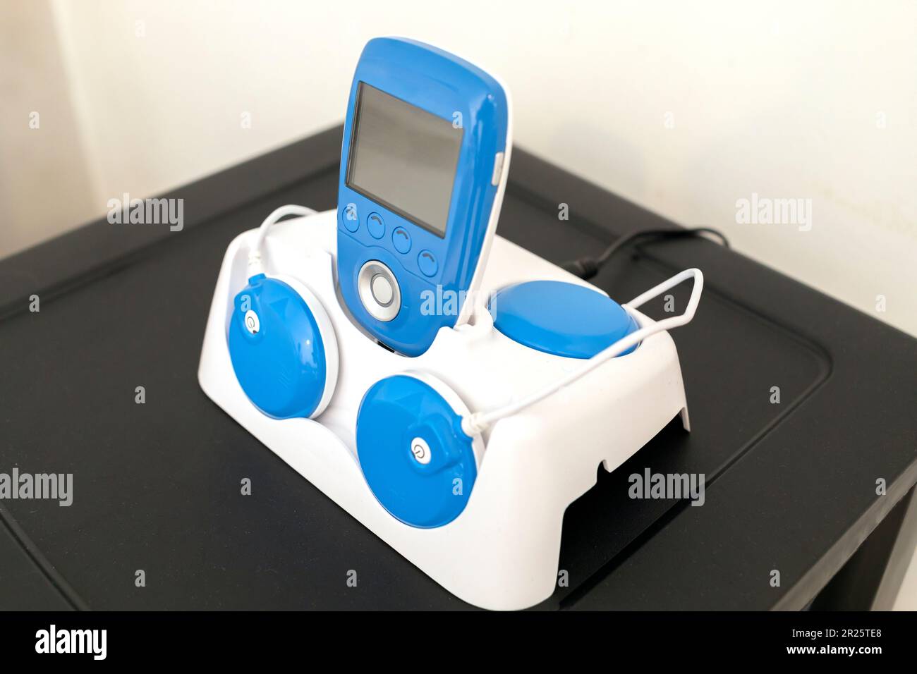 Closeup Blue Wireless Electric Muscle Stimulator, Pain Treatment on Shelf.  Charging Rehabilitation and Training Tool, Equipment. Healthcare and Stock  Photo - Alamy
