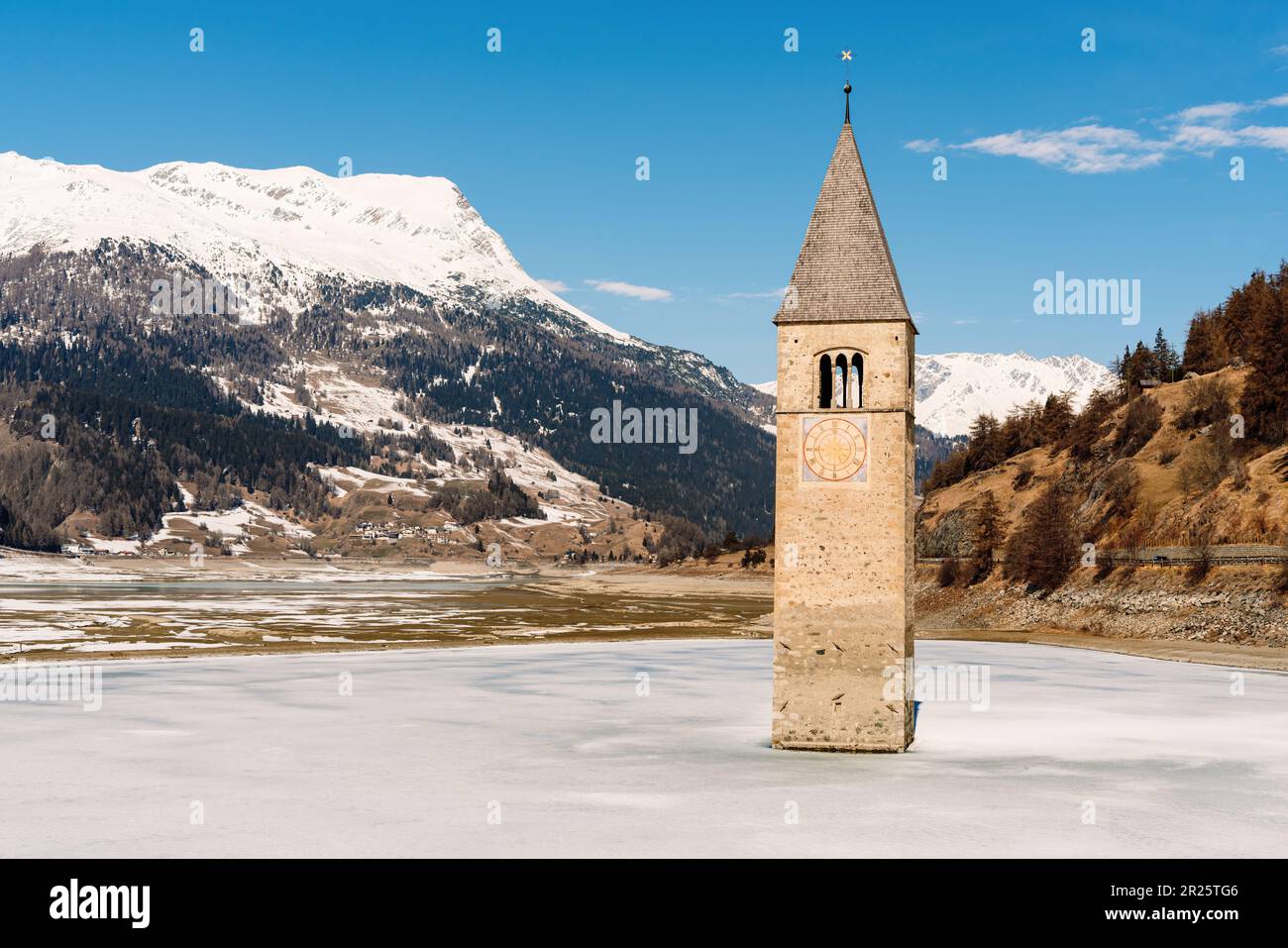 Famous 14th-century bell tower in frozen Reschensee, Lake Reschen and the old submerged village of Graun in Vinschgau Valley, South Tyrol, Italy. Stock Photo